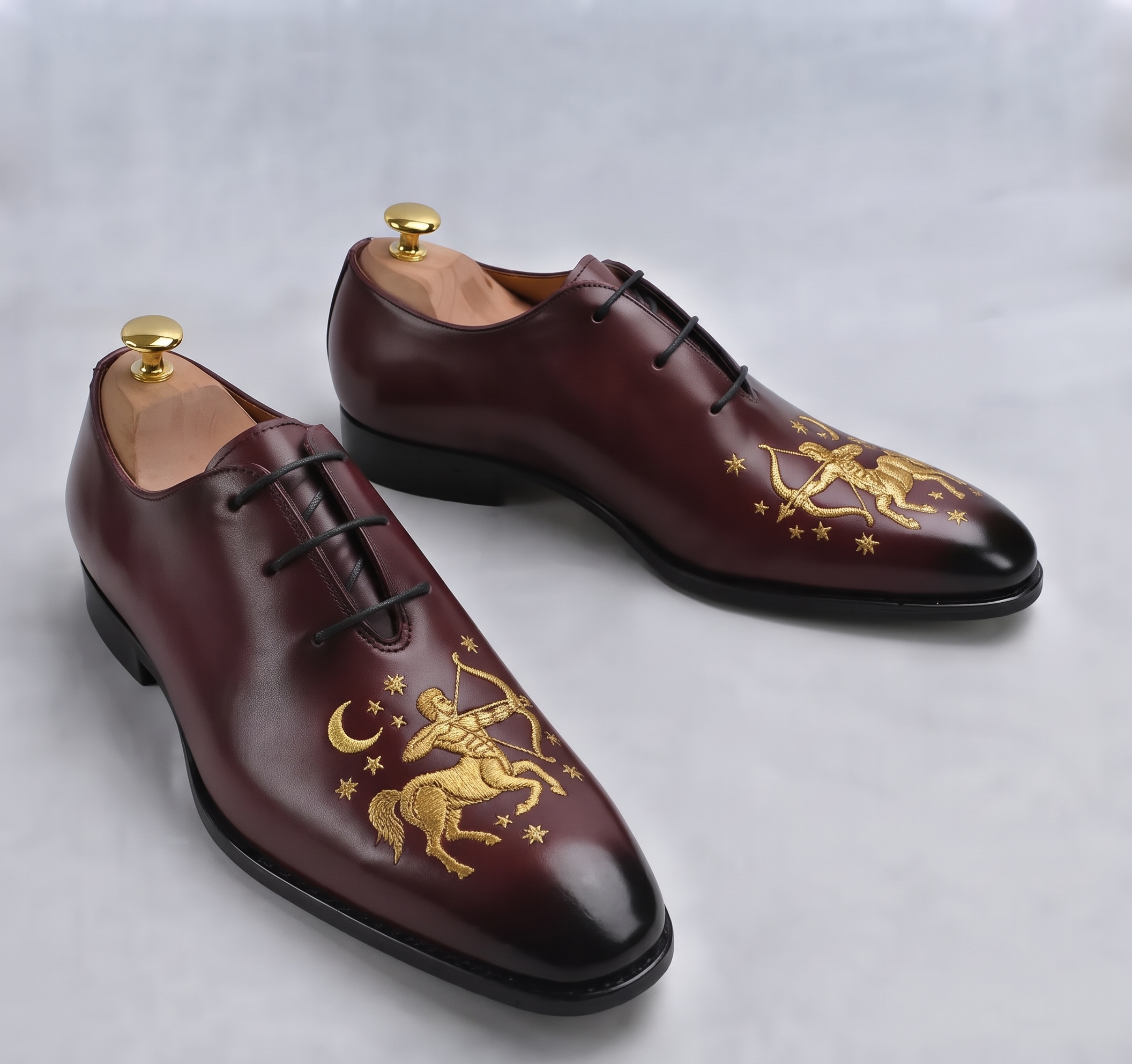 Burgundy leather Oxford shoes with gold zodiac sign embroidery