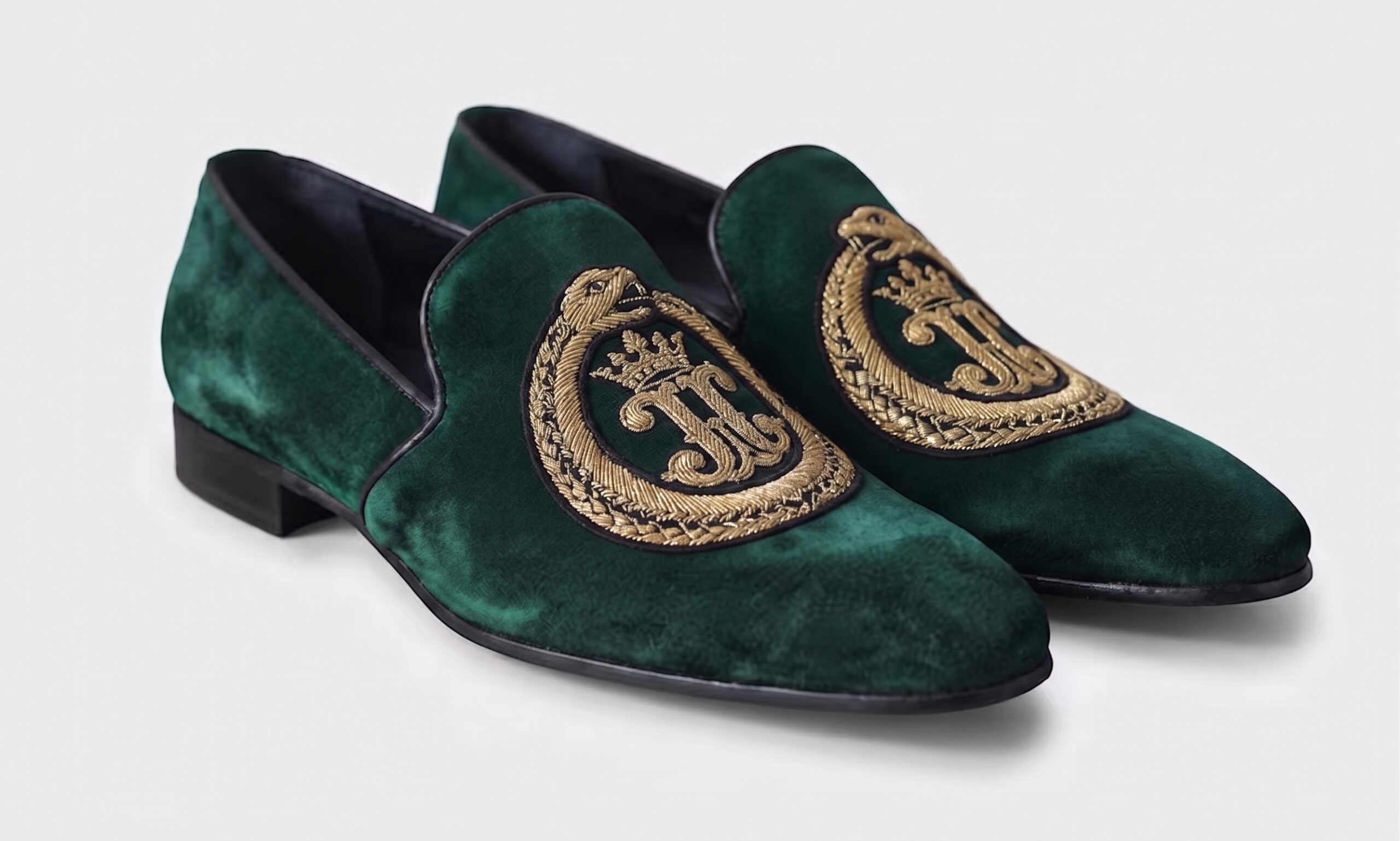 Emerald green velvet loafers with ornate gold embroidered detailing